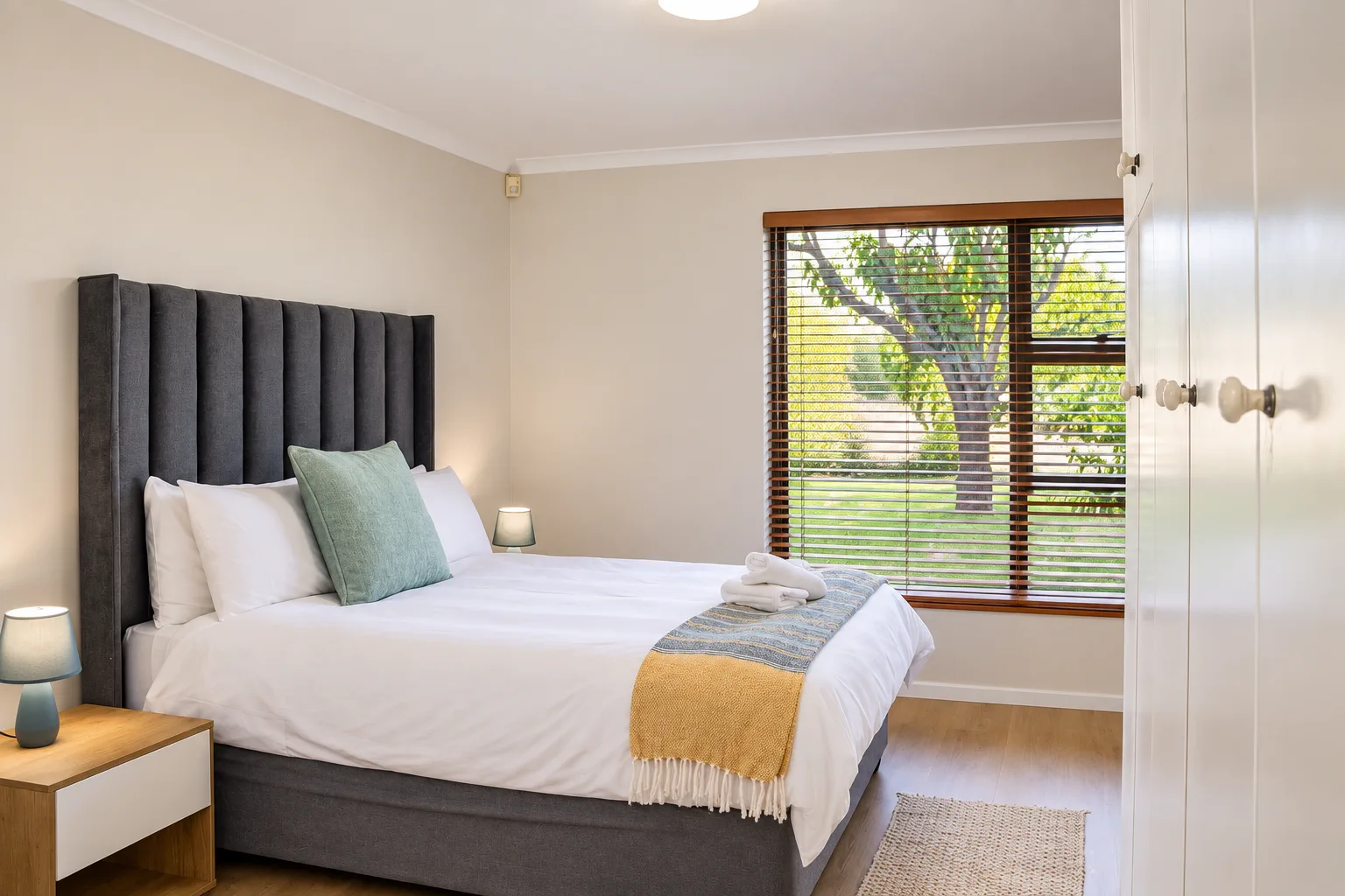 Bedroom 1, queen bed with tree view